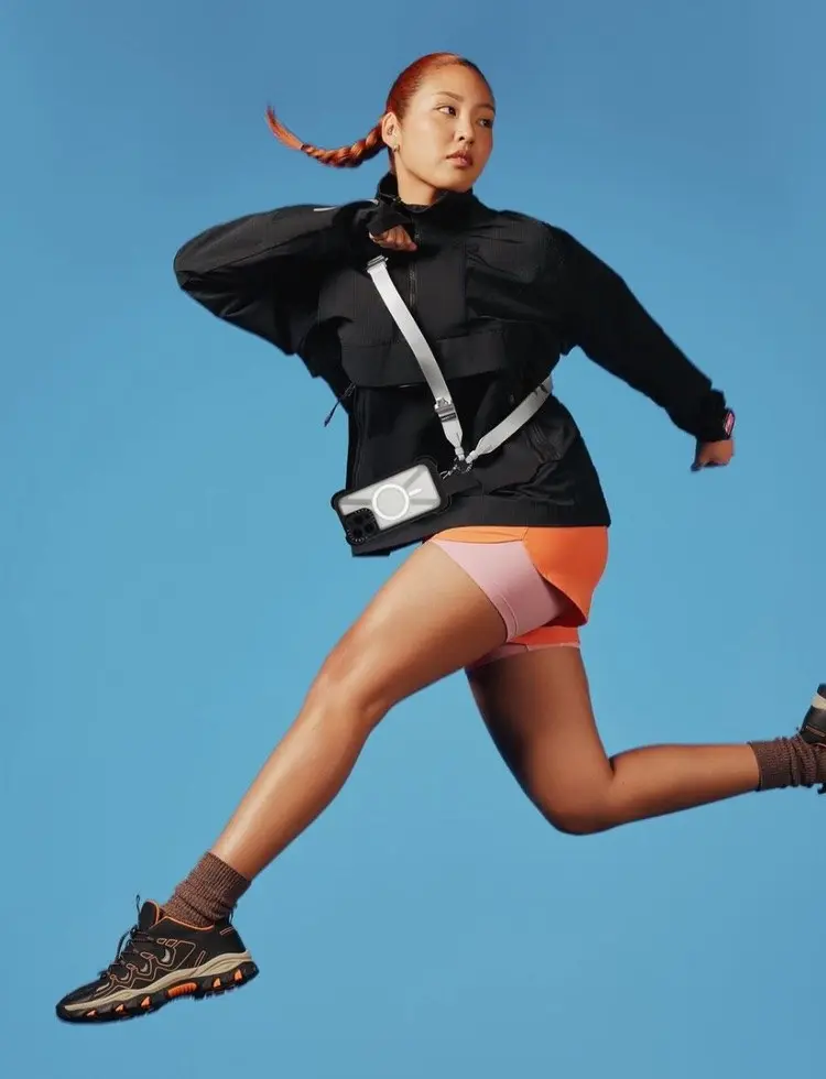 Model running with a Casetify phone case on a crossbody strap