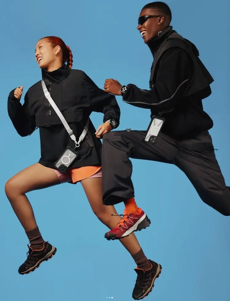 Two models mid-jump with Casetify crossbody phone cases