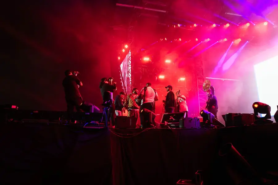 Luis Contreras and band under red festival lights