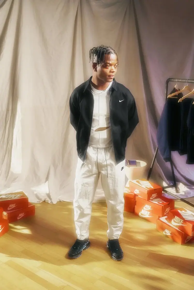 Taofeek Abijako in Nike with orange shoeboxes on the studio floor