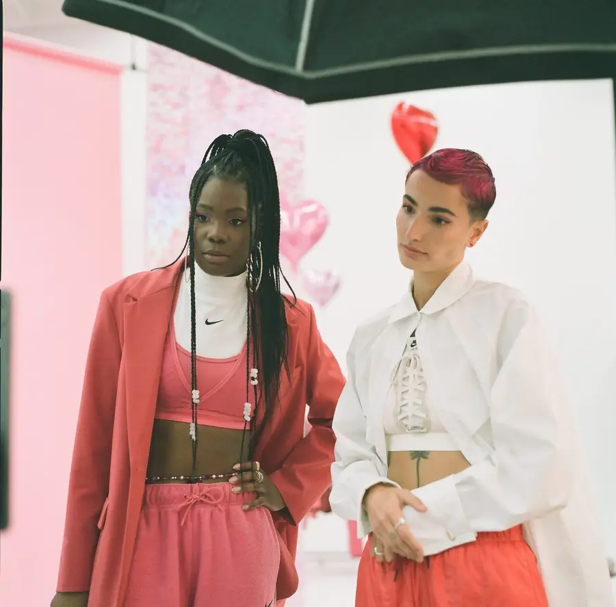 Two models in Nike on a Valentine’s Day studio set with heart balloons